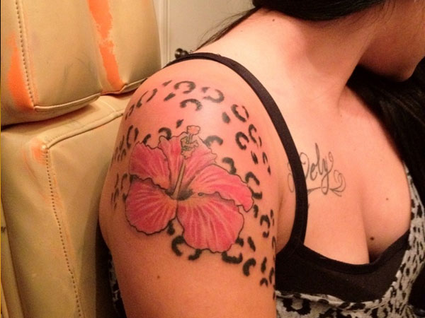 Pink Ink Hibiscus Flower Tattoo On Girl Right Shoulder