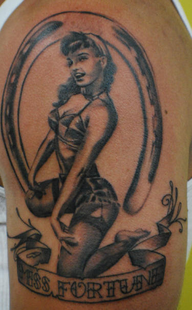 Pinup Girl And Horseshoe Tattoo On Left Shoulder