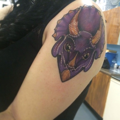 Purple Ink Dinosaur Tattoo On Left Shoulder