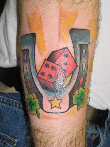 Red Dice And Horseshoe Tattoo On Arm