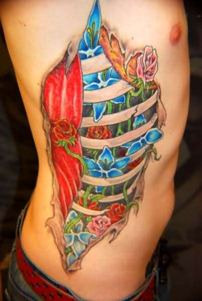 Ripped Skin Colorful Flowers Tattoo On Man Right Side Rib