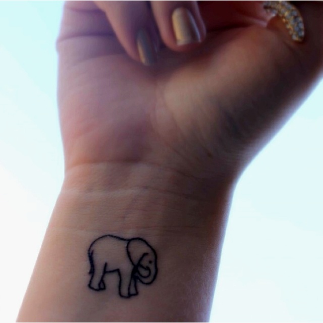 Simple Black Outline Baby Elephant Tattoo On Girl Wrist
