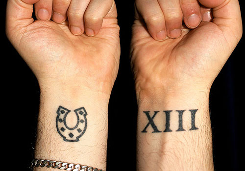 Simple Roman Numerals Horseshoe Tattoo On Wrist