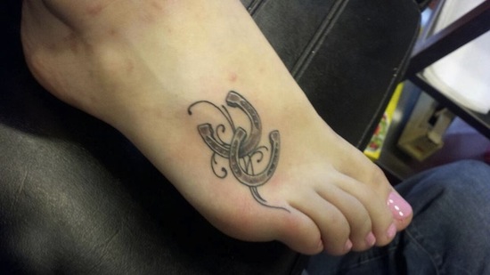 Small Grey Horseshoe Tattoo On Right Foot