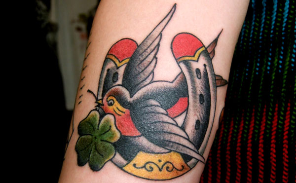 Swallow And Horse Shoe Tattoo On Bicep