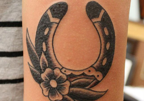 Traditional Flower And Horse Shoe Tattoo On Left Bicep