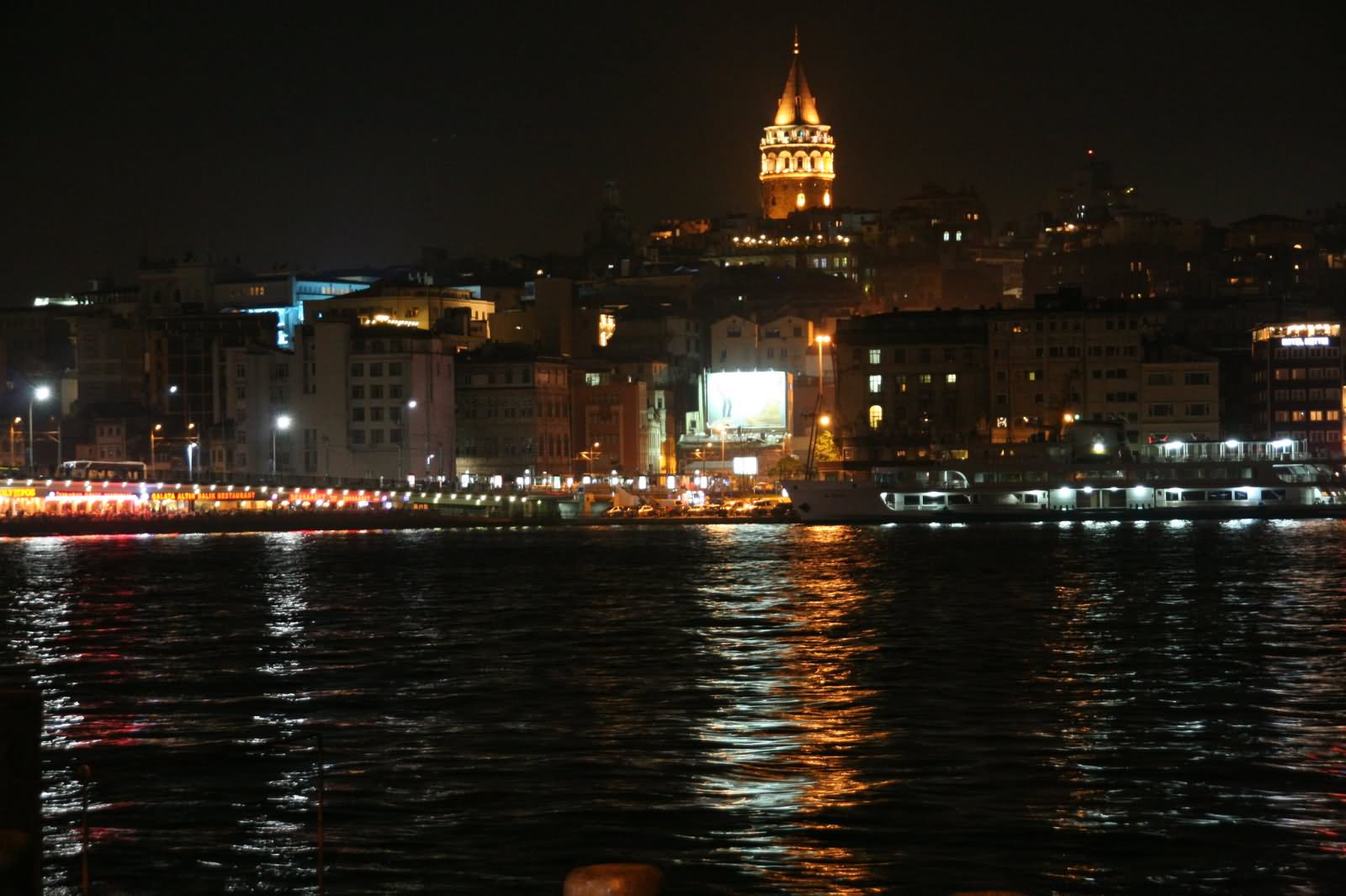 Water Reflection Of Galata Tower In Bosphorus River