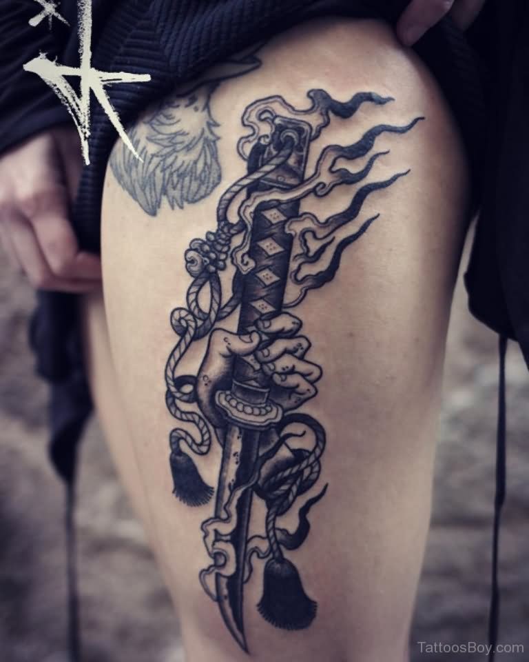 Black And Grey Dagger Tattoo On Side Thigh