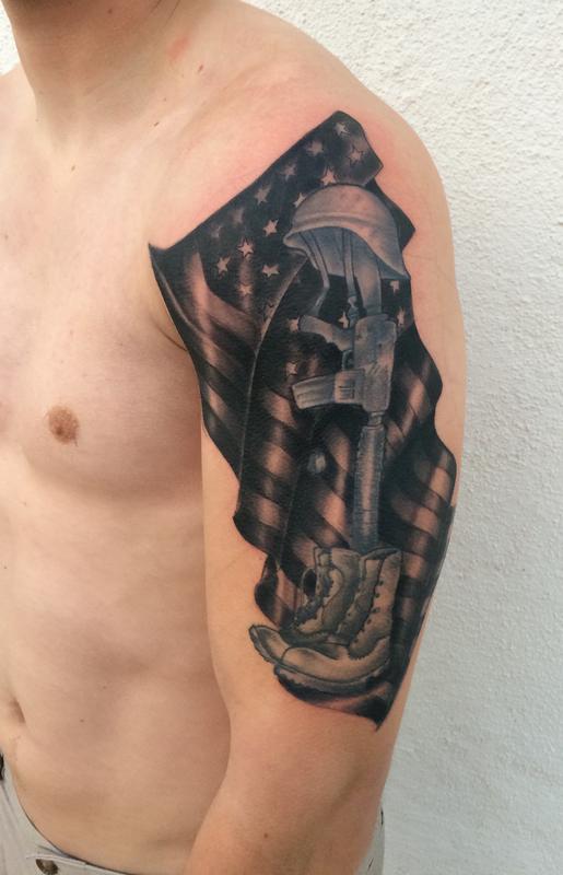 Black And Grey Memorial Military Equipments With USA Flag Tattoo On Man Left Half Sleeve