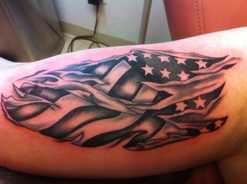 Black And Grey Ripped Skin USA Flag Tattoo Design For Bicep By Candice Frisby