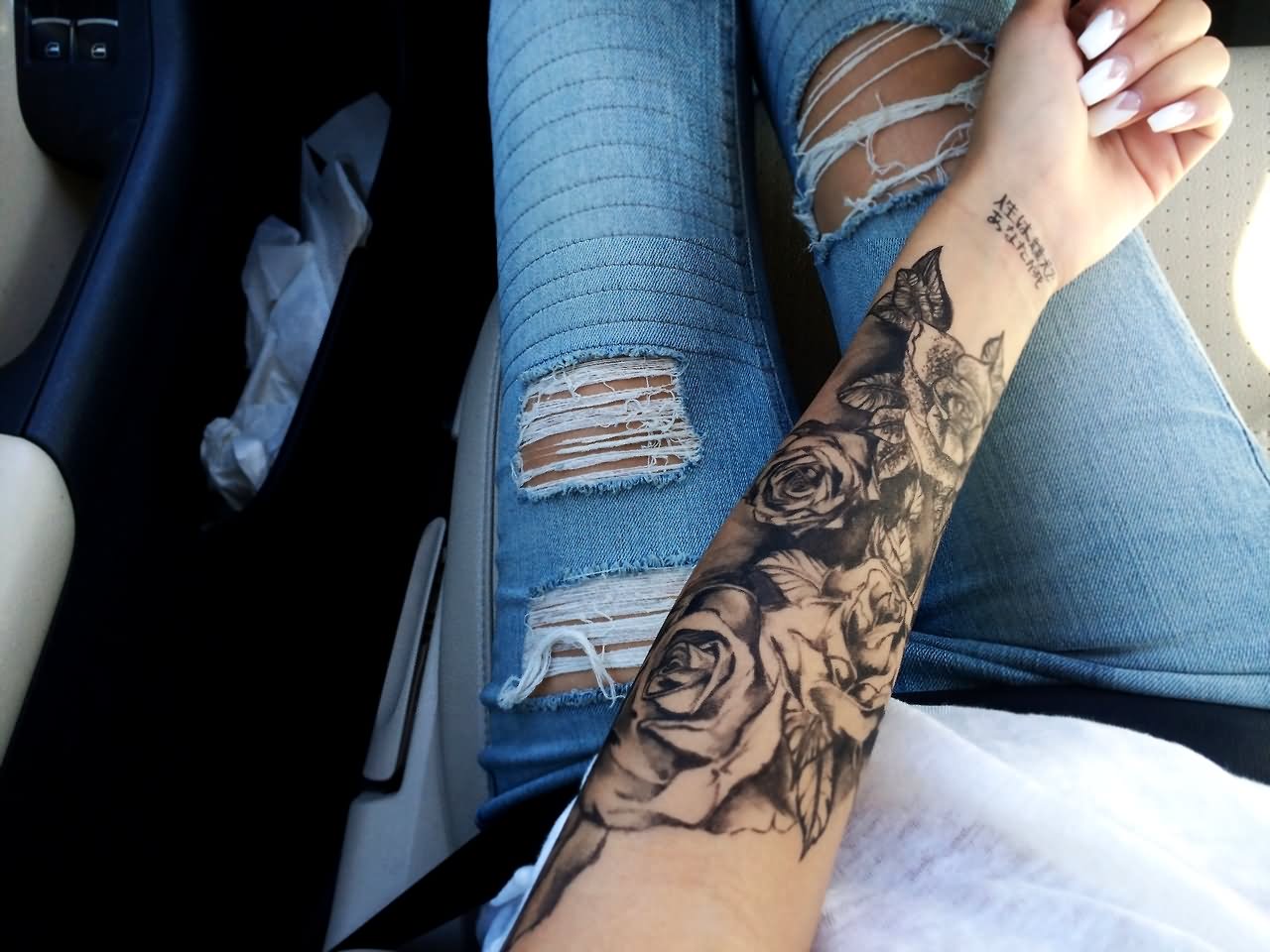 Black Ink Roses Tattoo On Girl Left Forearm