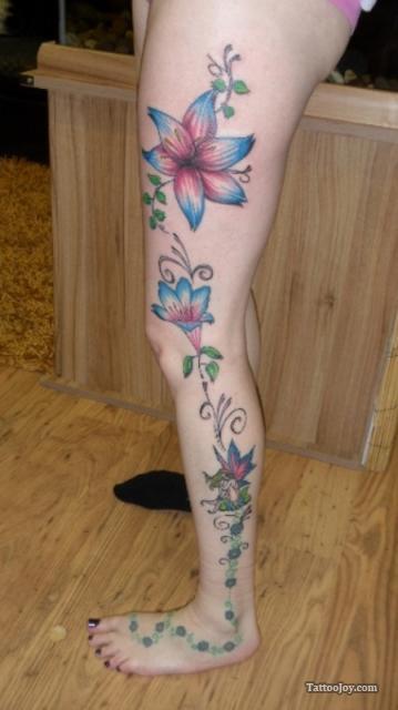 Colorful Flowers Tattoo On Girl Left Full Leg