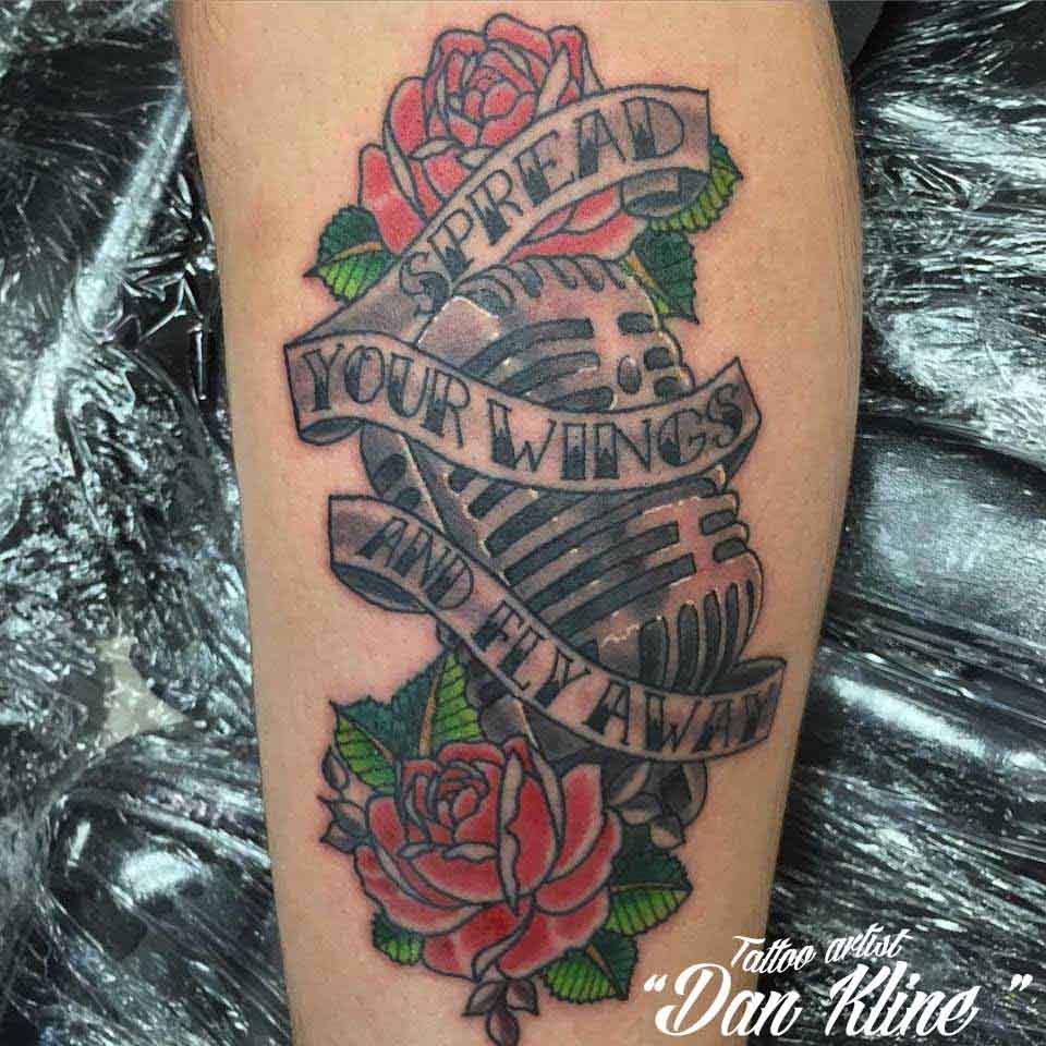Grey Banner And Microphone Rose Tattoo On Leg