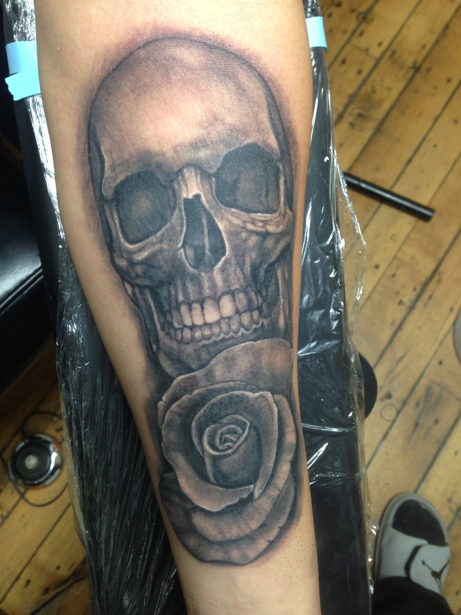 Grey Ink 3D Skull With Rose Tattoo Design For Forearm