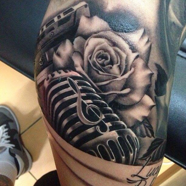 Grey Rose Flower And Microphone Tattoo On Leg