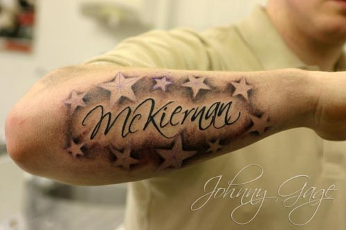 Mckiernan Name With Stars Tattoo On Right Forearm