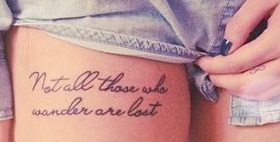 Not All Those Who Wander Are Lost Quote Tattoo On Girl Upper Leg