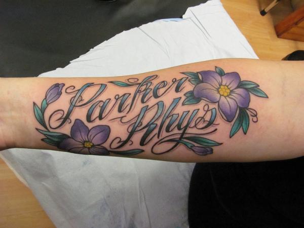 Parker Rhys Name With Flowers Tattoo Design For Forearm