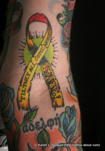 Red And Yellow Ribbon Tattoo On Sleeve