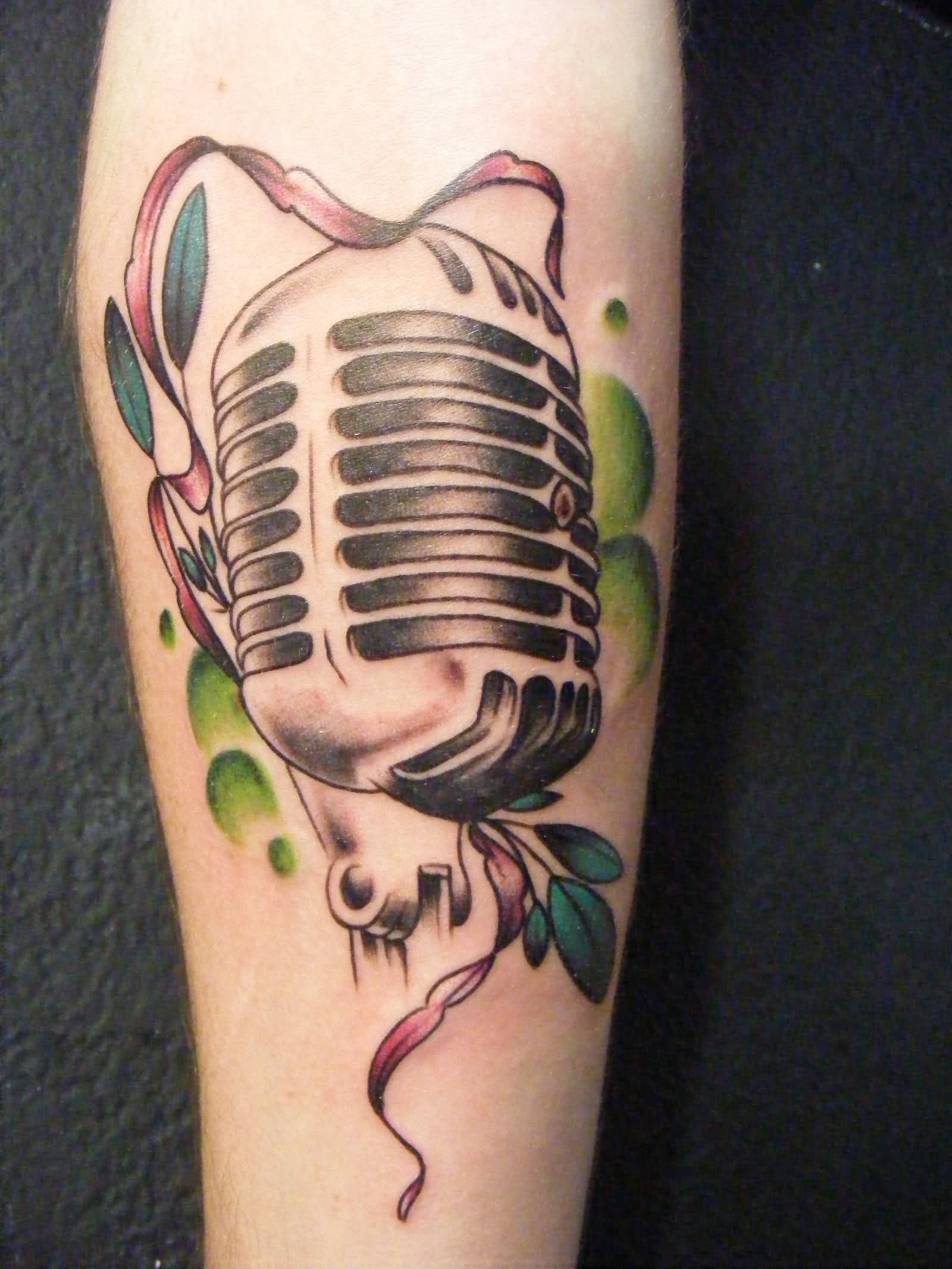 Red Ribbon And Microphone Tattoo On Leg.