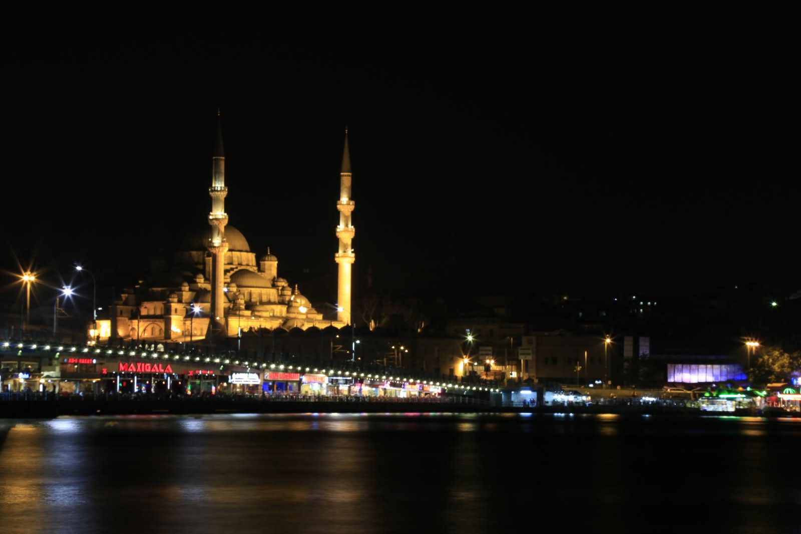 Side View Of Yeni Cami And Bridge At Night