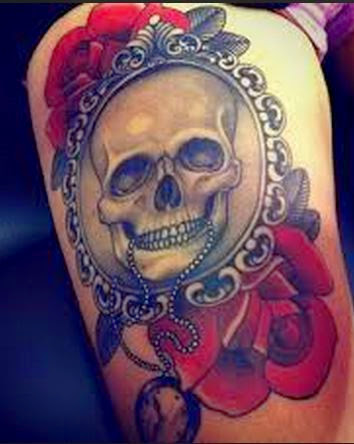 Skull In Frame And Red Roses Tattoo On Thigh