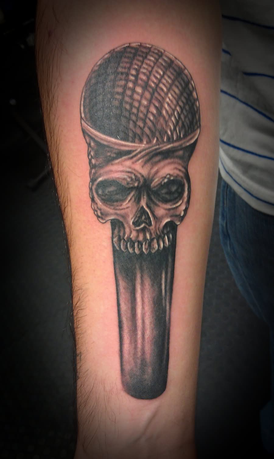 Skull Mic Tattoo On Forearm