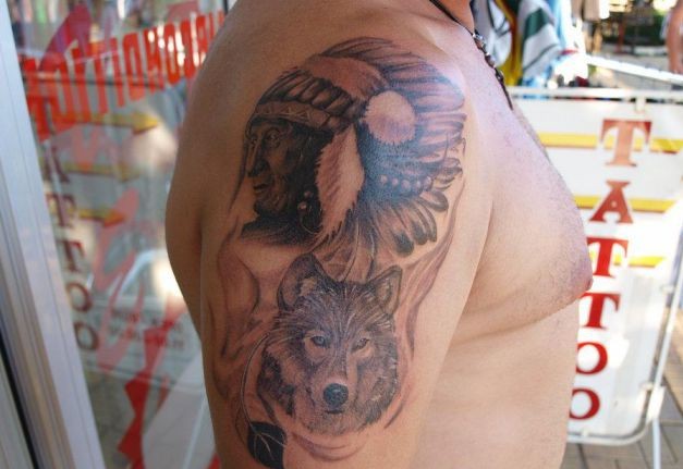 Attractive Indian Chief With Wolf Tattoo On Right Shoulder