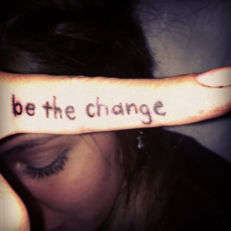 Be The Change Lettering Tattoo On Girl Side Finger