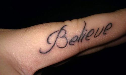 Believe Lettering Tattoo On Finger