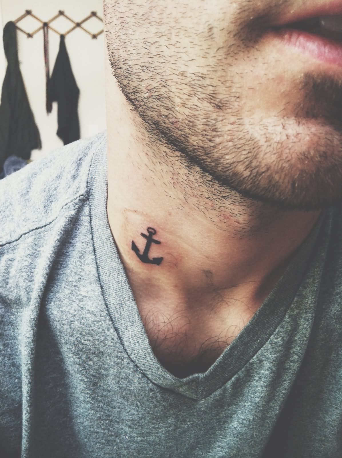 Black Anchor Tattoo On Man Neck