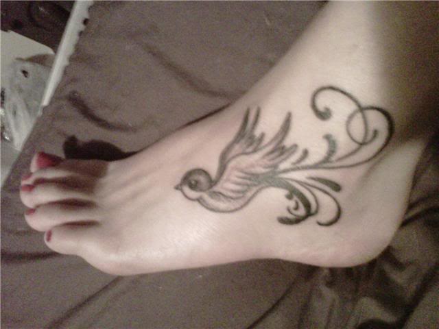 Black And Grey Bird Tattoo On Girl Left Foot