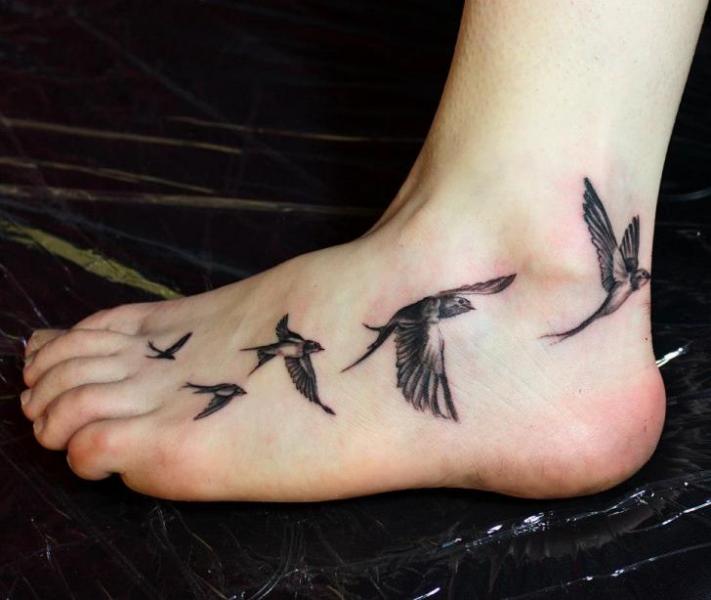 Black And Grey Flying Birds Tattoo On Left Foot
