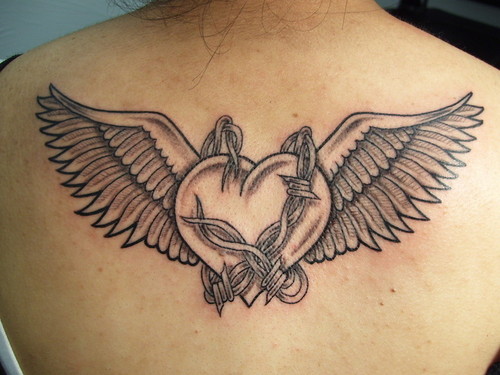 Black And Grey Gothic Heart With Wings And Barbed Tattoo On Upper Back