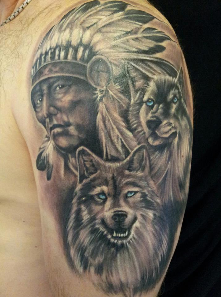 Black And Grey Indian Chief With Two Wolf Tattoo On Left Half Sleeve By Alec Logan