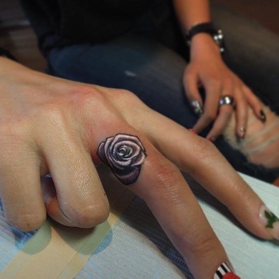 Black And Grey Rose Tattoo On Girl Finger
