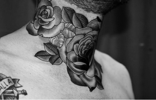 Black And Grey Roses Tattoo On Man Neck