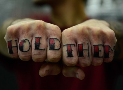 Black And Red Hold Them Knuckle Tattoo