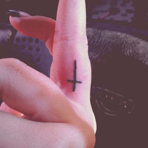 Black Cross Tattoo On Girl Side Finger