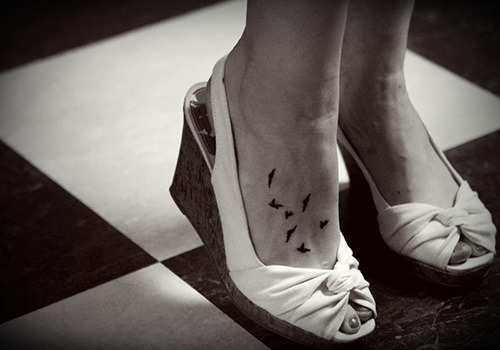Black Flying Birds Tattoo On Girl Foot
