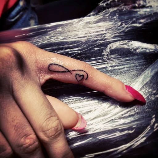 Black Infinity With Heart Tattoo On Finger