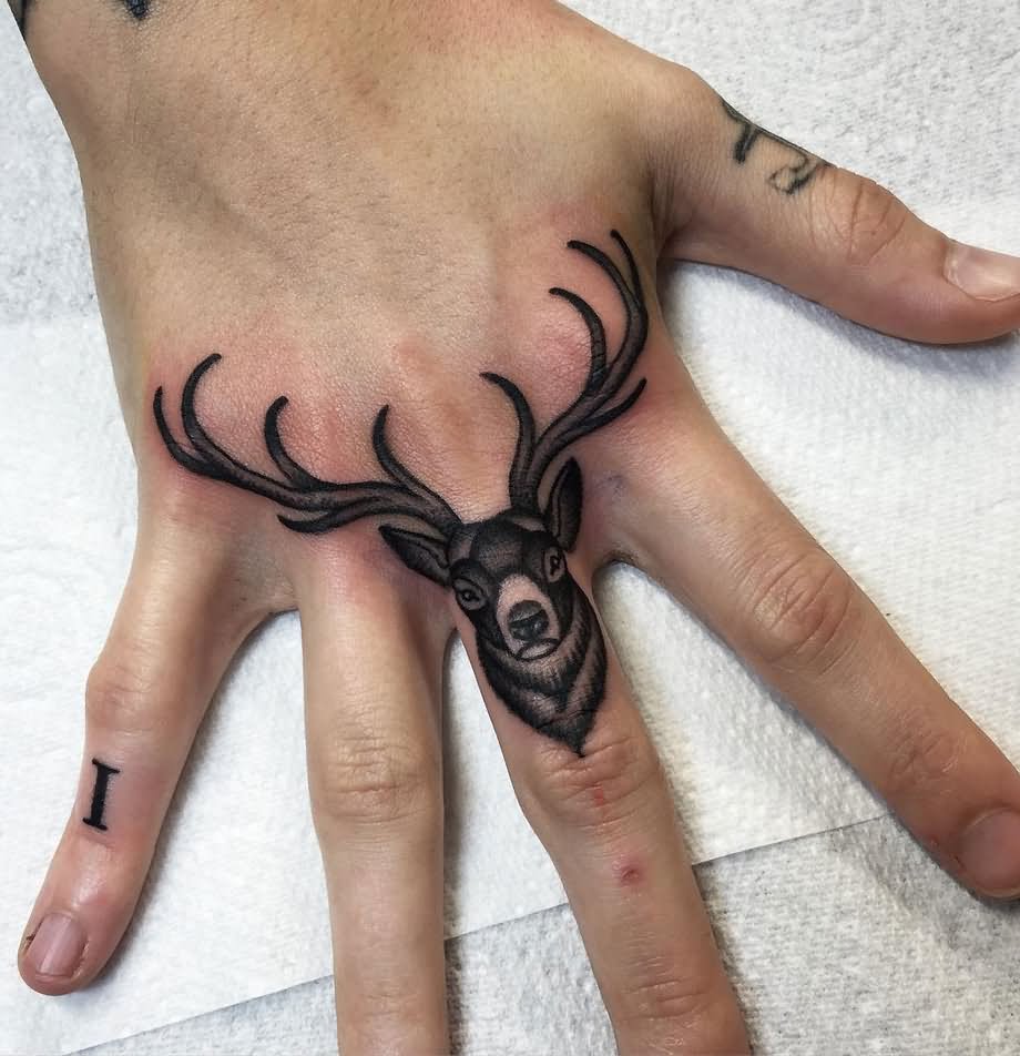 Black Ink Buck Tattoo On Finger