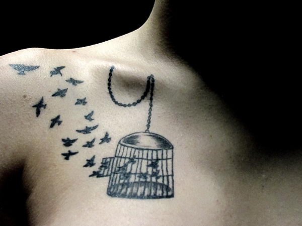 Black Ink Cage With Flying Birds Tattoo On Collar Bone