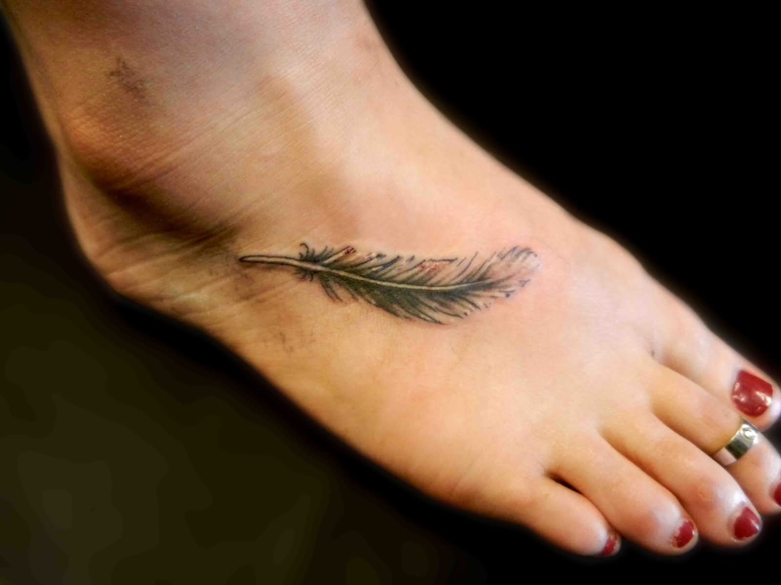 Black Ink Feather Tattoo On Girl Right Foot
