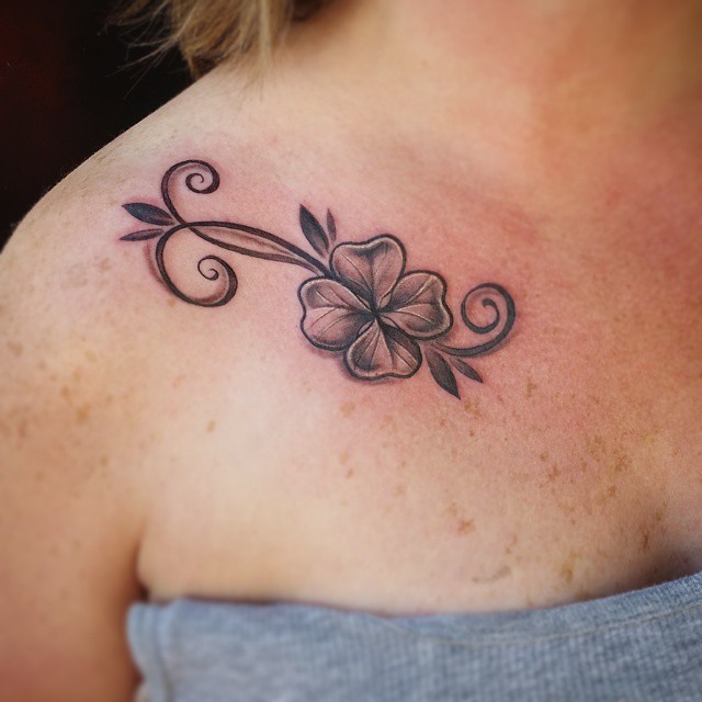 Black Ink Flower Tattoo On Girl Collar Bone
