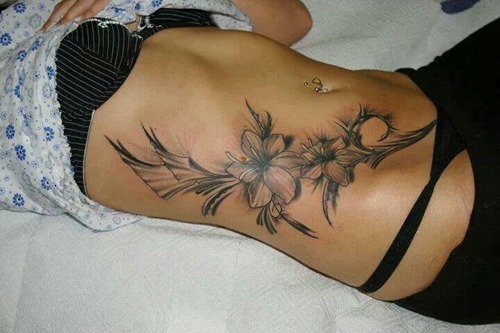 Black Ink Flowers Tattoo On Girl Stomach