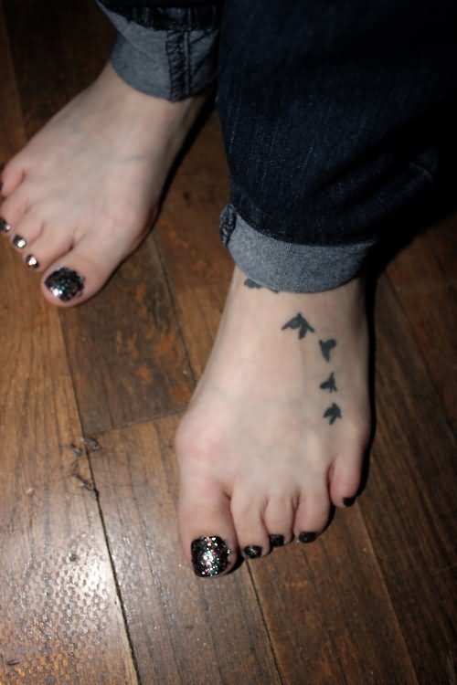 Black Ink Flying Birds Tattoo On Girl Left Foot