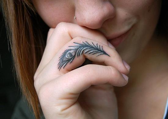 Black Ink Peacock Feather Tattoo On Girl Finger