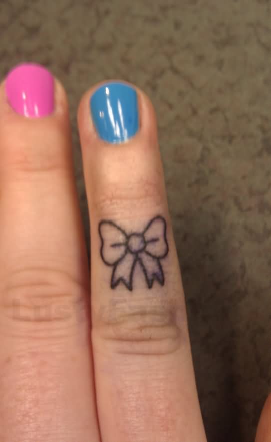 Black Outline Bow Ring Tattoo On Girl Finger
