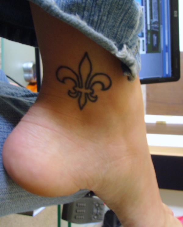 Black Outline Fleur de Lis Tattoo On Inner Ankle